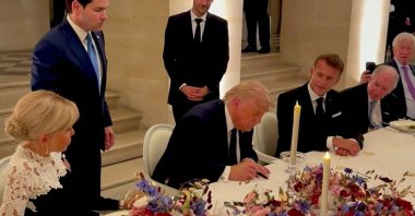 U.S. President Donald Trump (C) signs a deal with Iran to end the Middle East war, inside Chateau de Versailles, in Versailles, France, June 17, 2026. (AFP Photo)