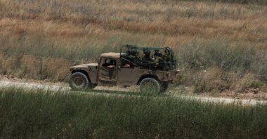 An Israeli military vehicle covered in an anti-drone mesh screen maneuvers on the Lebanese side of the border, June 18, 2026. (EPA Photo)