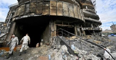Employees work at a mall previously destroyed during a Russian drone and missile strike in Kyiv, June 18, 2026, amid the Russian invasion in Ukraine. (AFP Photo)