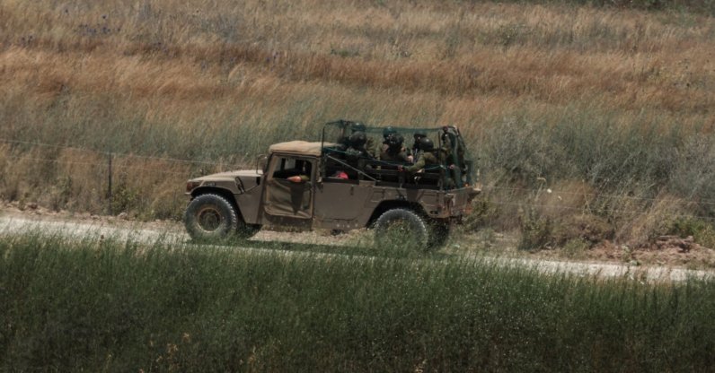 An Israeli military vehicle covered in an anti-drone mesh screen maneuvers on the Lebanese side of the border, June 18, 2026. (EPA Photo)