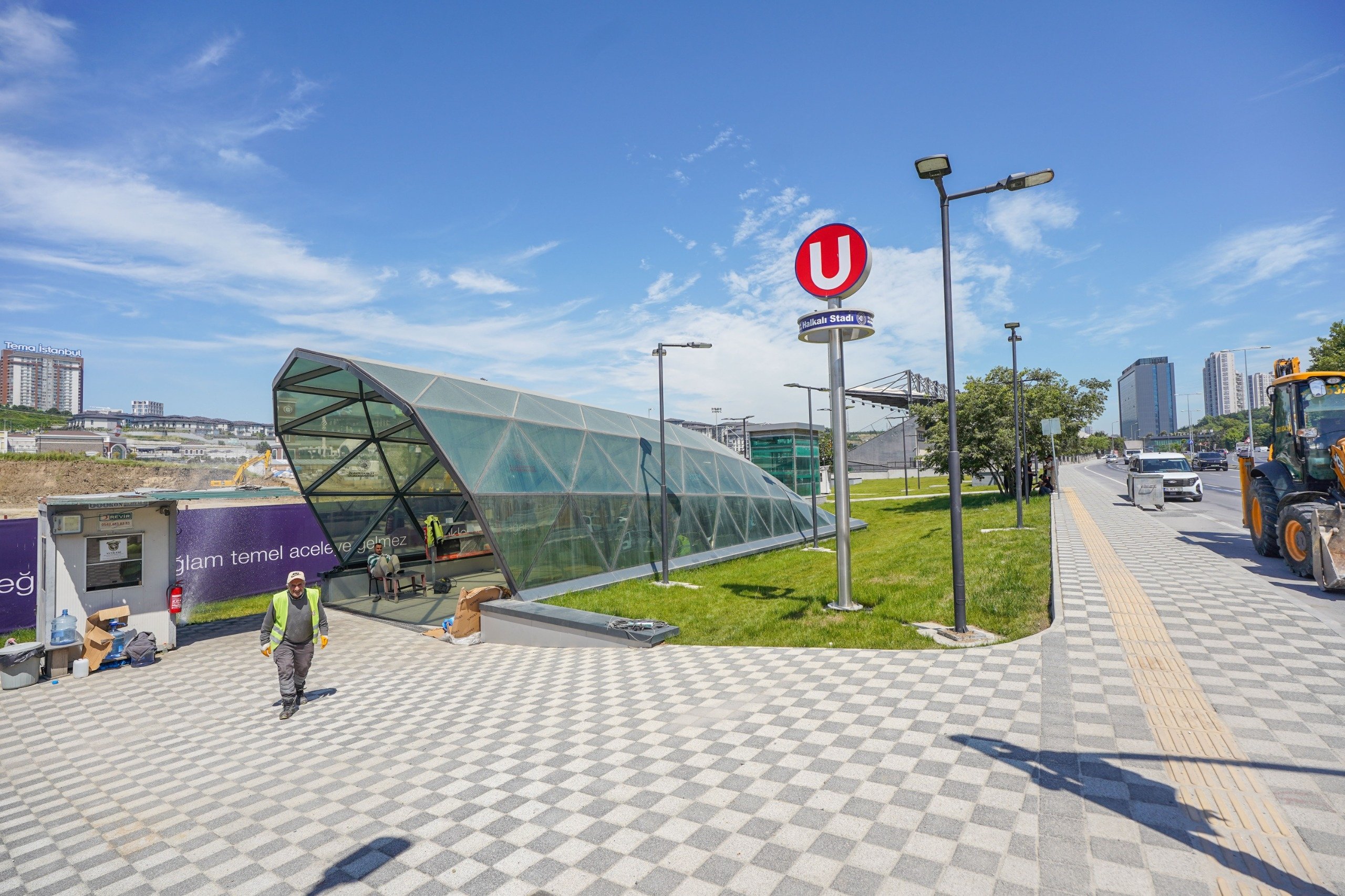 Workers are seen beside an entrance to the Halkalı Stadium station, Istanbul, Türkiye. (DHA Photo)