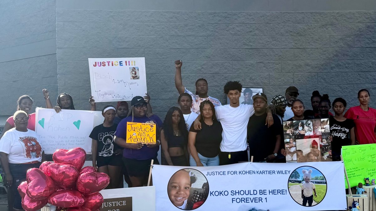 In this photo provided by Marquell Bridges, a group of mourners attend a makeshift memorial for 1-year old Kohen Wiley, outside the Walmart where the boy was shot by police in Senatobia, Miss., Wednesday, June 17, 2026. (AP Photo)