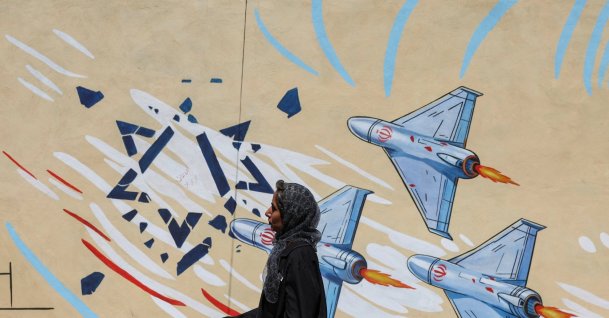 An Iranian woman walks past an anti-Israeli mural, after U.S. and Iranian officials said they had reached a deal to end their war and reopen the Strait of Hormuz, Tehran, Iran, June 15, 2026. (Reuters Photo)