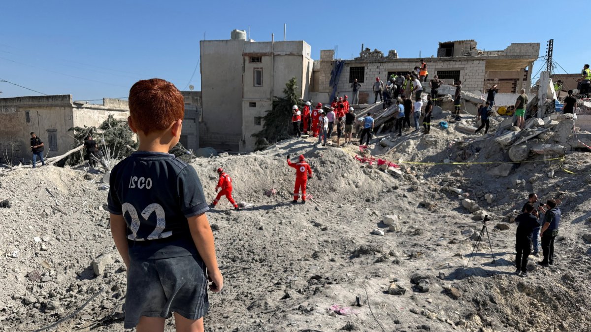 A child stands next to the rubble of a building damaged in an Israeli strike in Qennarit, southern Lebanon, June 20, 2026. (Reuters Photo)