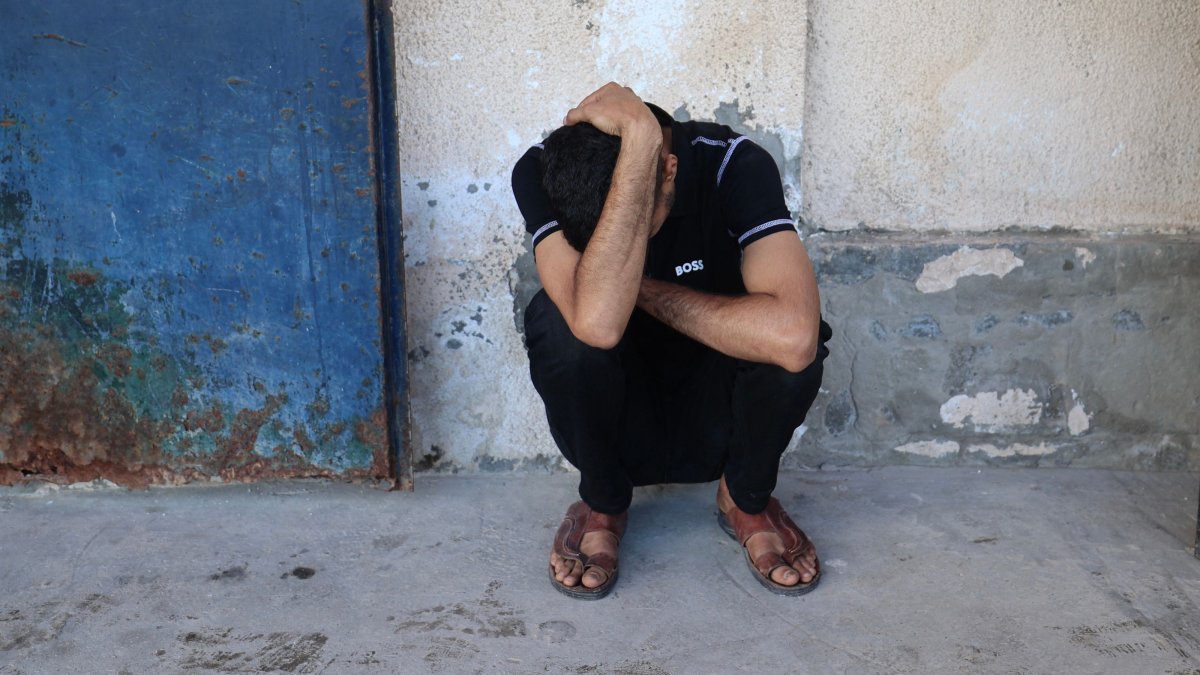 A friend of Al Jazeera video journalist Ahmed Wishah, who was killed in an Israeli strike, mourns at Al-Aqsa Martyrs Hospital in Deir al-Balah, in the central Gaza Strip, Palestine, June 21, 2026. (AFP Photo)