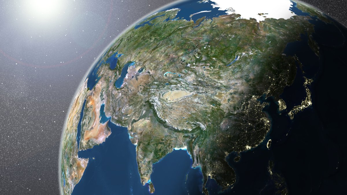 A true-color satellite image of the Earth showing Asia, half in shadow, and the sun. (Getty Images Photo)