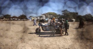 A Sudanese refugee family rides on a motorized cart travelling between Chad and Sudan, Tine, eastern Chad, Nov. 22, 2025. (Reuters Photo)