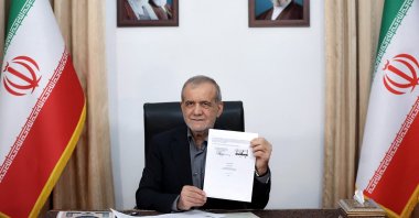 Iranian President Masoud Pezeshkian shows the document of the U.S. Memorandum of Understanding, Tehran, Iran, June 18, 2026. (Reuters Photo)