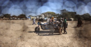 A Sudanese refugee family rides on a motorized cart travelling between Chad and Sudan, Tine, eastern Chad, Nov. 22, 2025. (Reuters Photo)