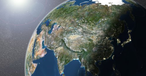 A true-color satellite image of the Earth showing Asia, half in shadow, and the sun. (Getty Images Photo)