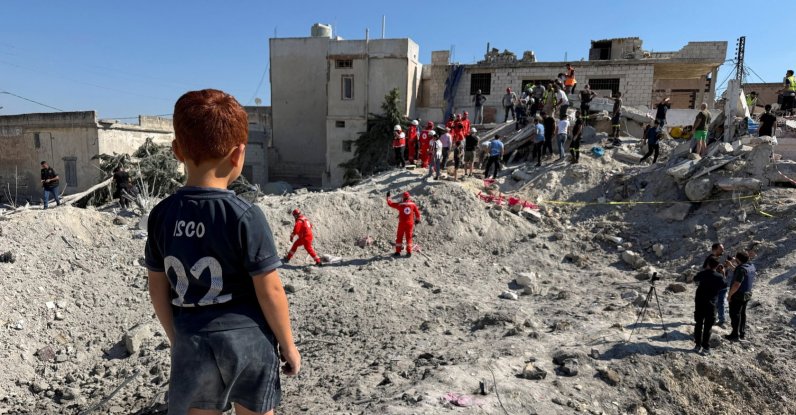 A child stands next to the rubble of a building damaged in an Israeli strike in Qennarit, southern Lebanon, June 20, 2026. (Reuters Photo)