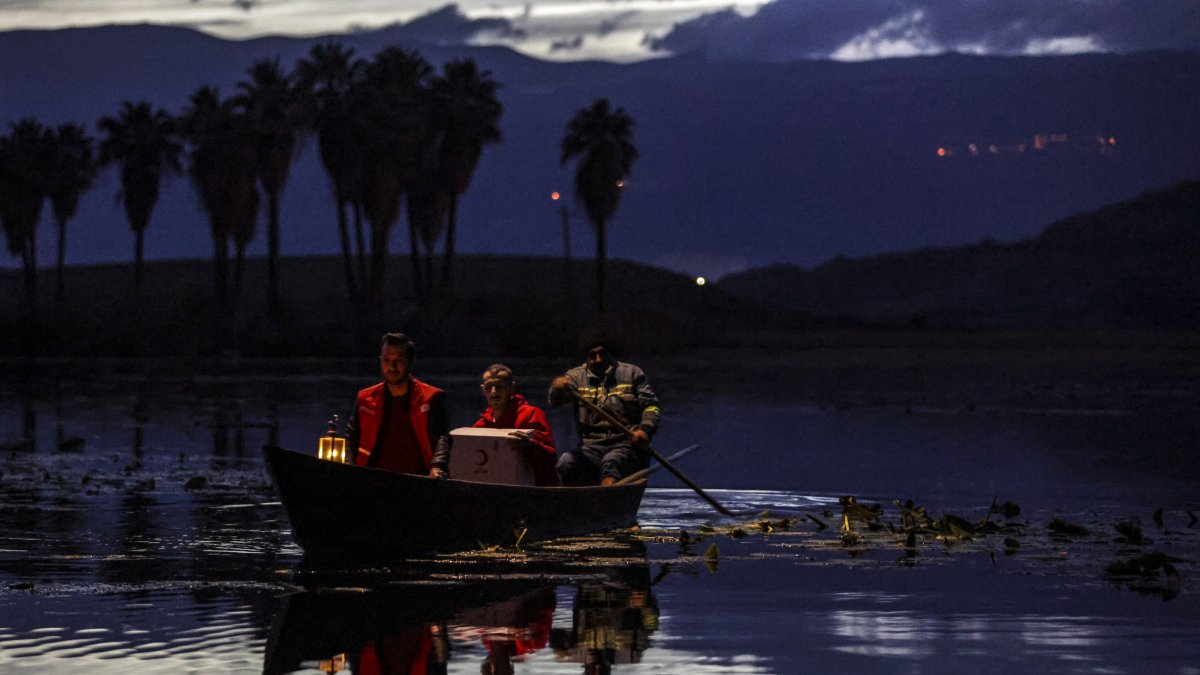 Turkish Red Crescent teams deliver aid supplies by boat to 93-year-old Halime Sual, who lives alone on an island in the middle of Lake Gölbaşı, Hatay, Türkiye, June 21, 2026. (DHA Photo)