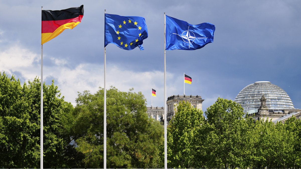 A German, a European and a NATO flag wave in the wind at the chancellery in Berlin, Germany, July 9, 2025. (AP Photo)