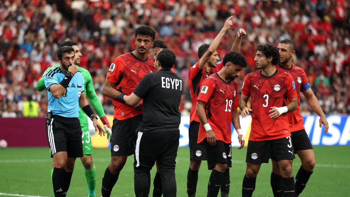 Hossam Abdelmaguid #4 of Egypt is attended to by teammates and team staff after sustaining a left eye injury during the FIFA World Cup 2026 Group G match between New Zealand and Egypt at BC Place, Vancouver, British Columbia, Canada, June 21, 2026. (AFP Photo)