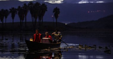 Turkish Red Crescent teams deliver aid supplies by boat to 93-year-old Halime Sual, who lives alone on an island in the middle of Lake Gölbaşı, Hatay, Türkiye, June 21, 2026. (DHA Photo)