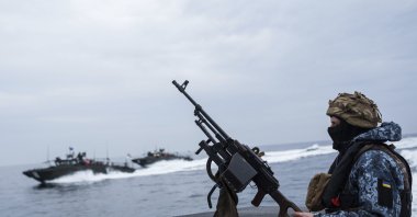 A Ukrainian serviceman of Military Naval Forces stands on a boat during patrol over Black Sea coast line of Odesa region, Ukraine, March 27, 2025. (AP Photo)