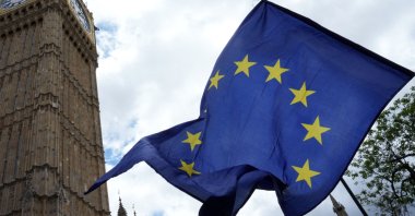An EU flag is waved beside The Elizabeth Tower, commonly known by the name of the clock's bell "Big Ben," during a National 'Rejoin the EU' march in central London, U.K., June 20, 2026. (AFP Photo)