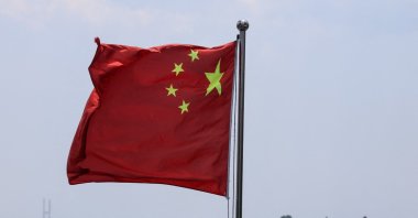 The Chinese national flag flies in the wind over the Yalu River, with buildings of the North Korean city of Sinuiju behind, on the bank across, in Dandong, Liaoning province, China, June 8, 2026. (Reuters Photo)