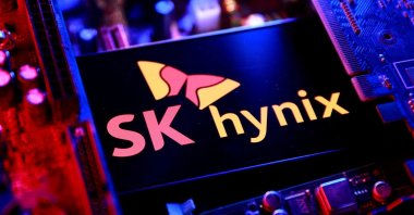 The SK Hynix logo and a computer motherboard appear in this illustration taken Aug. 25, 2025. (Reuters Photo)