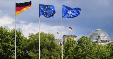 A German, a European and a NATO flag wave in the wind at the chancellery in Berlin, Germany, July 9, 2025. (AP Photo)