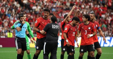 Hossam Abdelmaguid #4 of Egypt is attended to by teammates and team staff after sustaining a left eye injury during the FIFA World Cup 2026 Group G match between New Zealand and Egypt at BC Place, Vancouver, British Columbia, Canada, June 21, 2026. (AFP Photo)