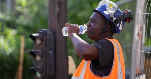 A worker drinks water at a construction site as temperatures rise during a heatwave, Paris, France, June 22, 2026. (Reuters Photo)