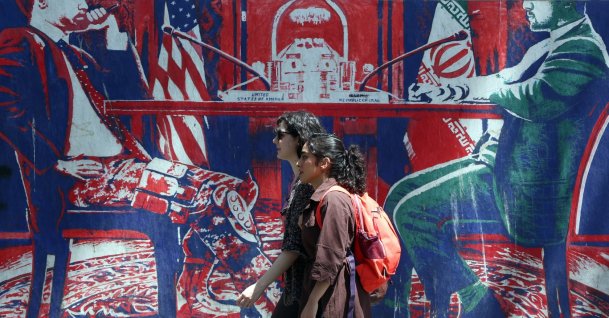 Iranian girls walk past an anti-U.S. mural next to the former U.S. embassy in Tehran, Iran, June 22, 2026. (EPA Photo)