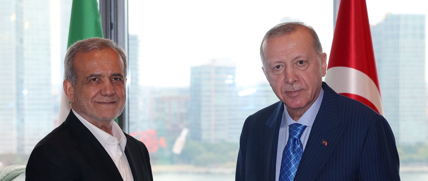 President Recep Tayyip Erdoğan and Iranian President Masoud Pezeshkian shake hands at the Turkish House in New York, Sept. 23, 2024. (DHA File Photo)