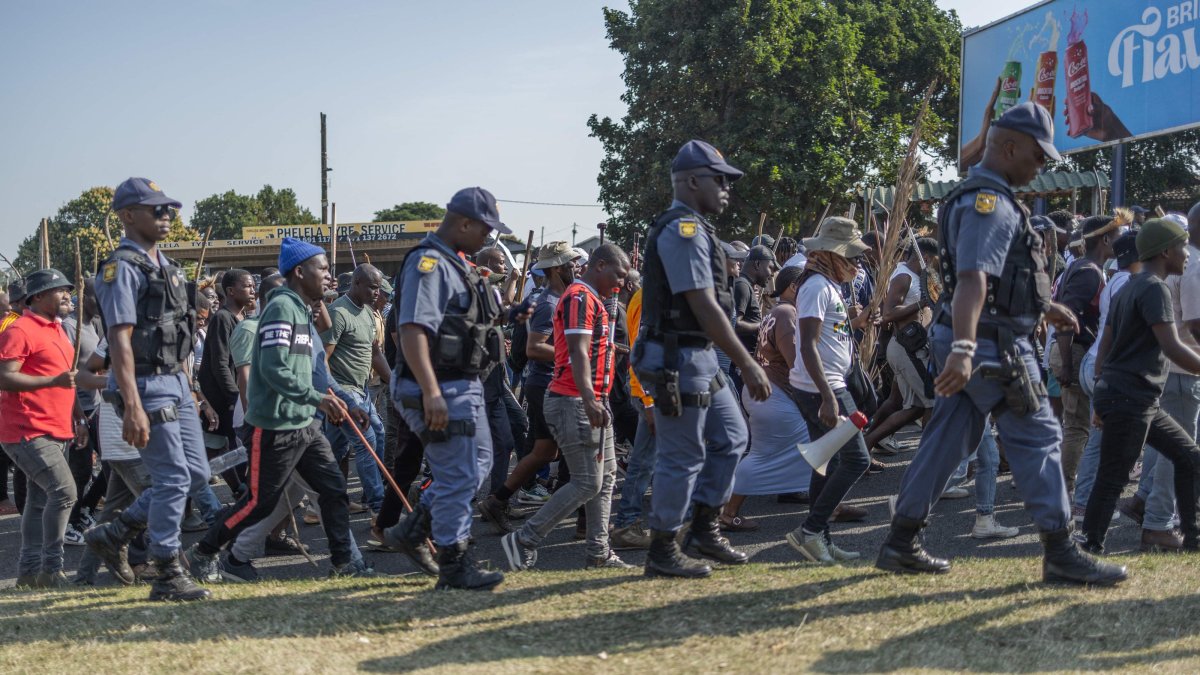 Members of the South African Police Service (SAPS) escort protesters from "March and March” Movement during a demonstration, Durban, South Africa, June 22, 2026. (AFP Photo)