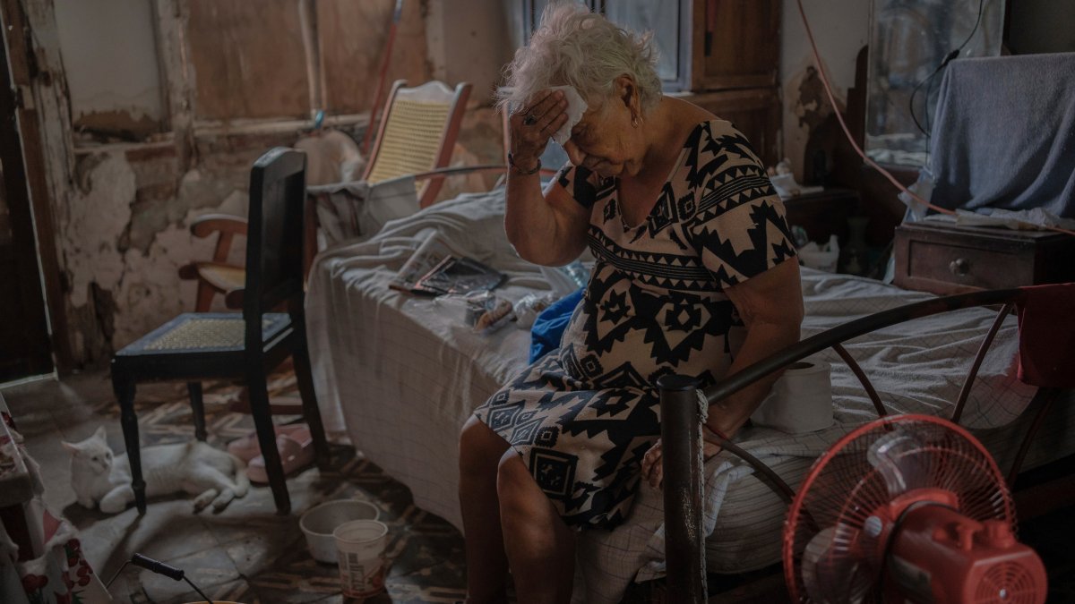 Margarita Salazar, 82, wipes the sweat off with a tissue inside her home amid hot weather in Veracruz, Mexico, June 16, 2024. (AP Photo)