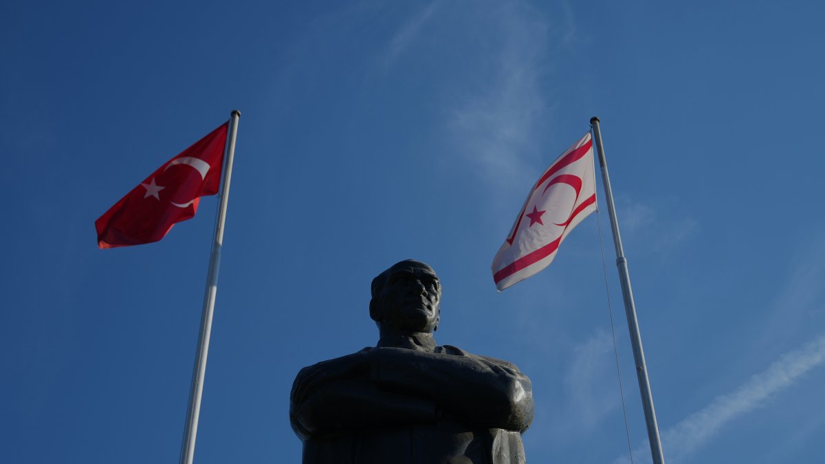 Turkish and Turkish Republic of Northern Cyprus (TRNC) flags are seen with a statue of Mustafa Kemal Atatürk, Nicosia (Lefkoşa), island of Cyprus, Oct. 17, 2025. (AP File Photo)