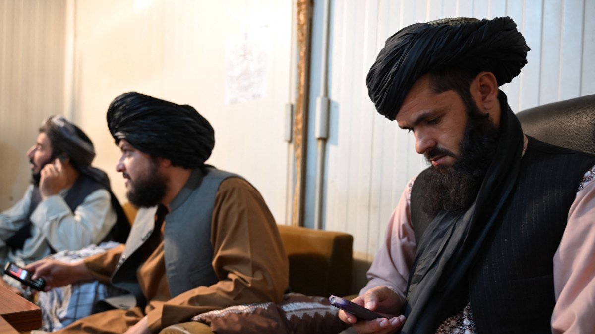 Taliban administrative staff use feature phones at the Department of Information and Culture building in Kandahar, June 22, 2026. (AFP Photo)