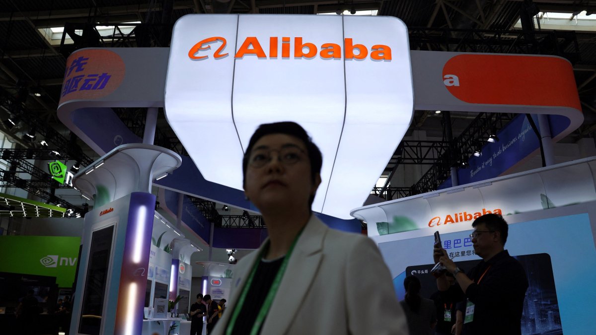 People walk past the Alibaba booth during the China International Supply Chain Expo (CISCE) in Beijing, China June 22, 2026. (Reuters Photo)