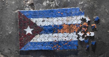 A mosaic depicting the Cuban flag in the shape of a puzzle is seen assembled from colored pieces on a section of a coastal fortification wall along the seafront, Havana, Cuba, June 18, 2026. (AFP Photo)