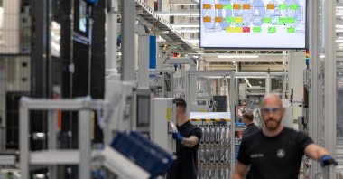 Workers assemble axial-flux motors for electric vehicles on an assembly line at the Mercedes-Benz engine factory in Berlin, Germany, June 9, 2026. (Reuters Photo)