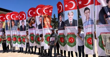 
People hold pictures of victims during the remembrance events, in Reyhanlı, in Hatay, southern Türkiye, May 11, 2022. (IHA Photo)