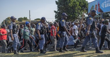 Members of the South African Police Service (SAPS) escort protesters from "March and March” Movement during a demonstration, Durban, South Africa, June 22, 2026. (AFP Photo)