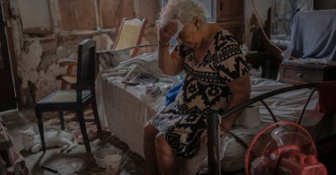 Margarita Salazar, 82, wipes the sweat off with a tissue inside her home amid hot weather in Veracruz, Mexico, June 16, 2024. (AP Photo)
