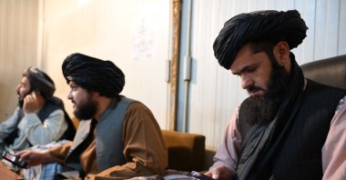 Taliban administrative staff use feature phones at the Department of Information and Culture building in Kandahar, June 22, 2026. (AFP Photo)