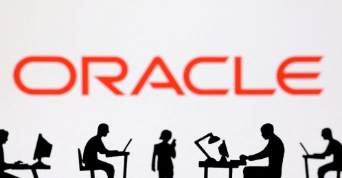 Figurines with computers and smartphones are seen in front of the Oracle logo in this illustration taken on Feb. 19, 2024. (Reuters Photo)