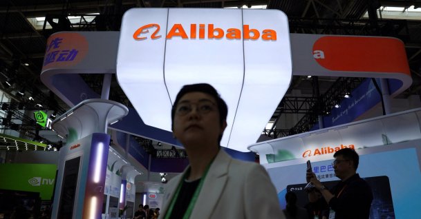 People walk past the Alibaba booth during the China International Supply Chain Expo (CISCE) in Beijing, China June 22, 2026. (Reuters Photo)