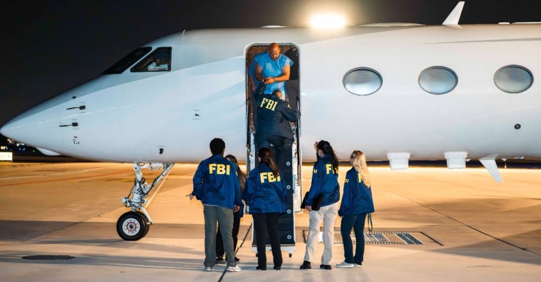 Federal Bureau of Investigation (FBI) agents escort the suspect to an aircraft following his detention in Türkiye. (Courtesy of FBI)
