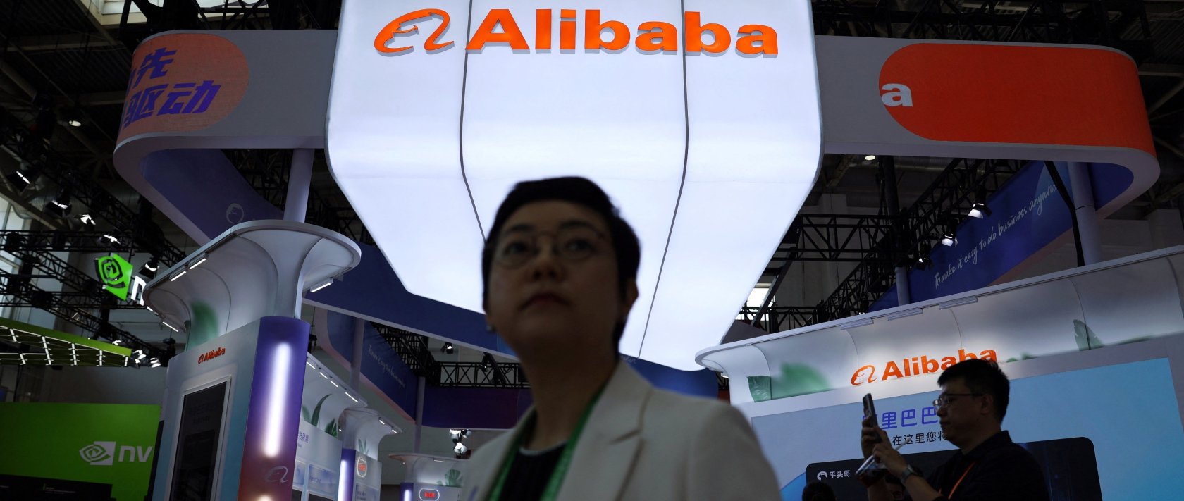 People walk past the Alibaba booth during the China International Supply Chain Expo (CISCE) in Beijing, China June 22, 2026. (Reuters Photo)