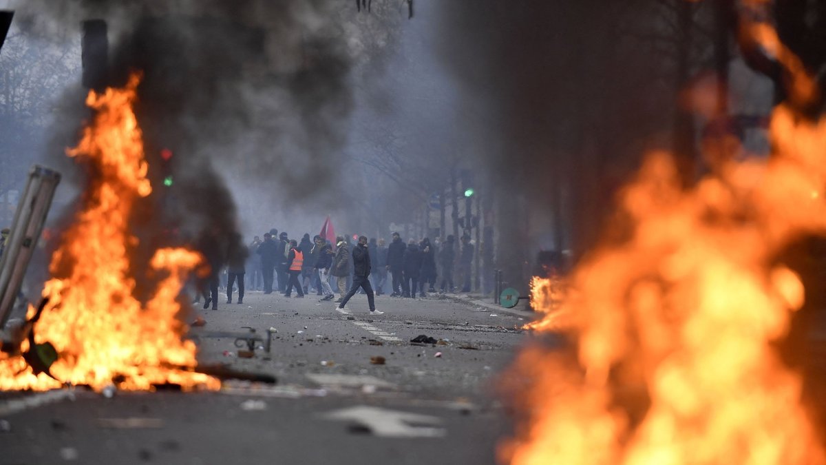 PKK terror group supporters face riot police as clashes erupt, at The Place de la Republique, in Paris, France, Dec. 24, 2022. (AFP Photo)