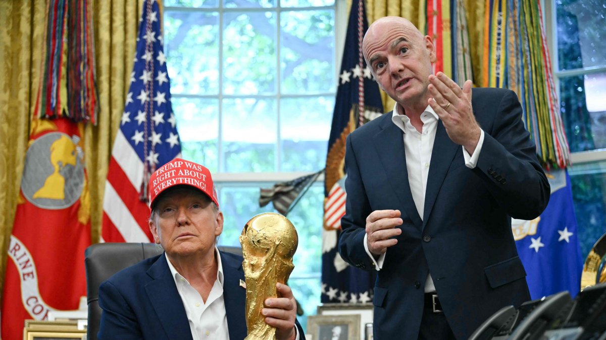 U.S. President Donald Trump (L), joined by FIFA president Gianni Infantino, holds the World Cup Trophy as he announces the Oval Office of the White House, Washington, U.S., Aug. 22, 2025. (AFP Photo)