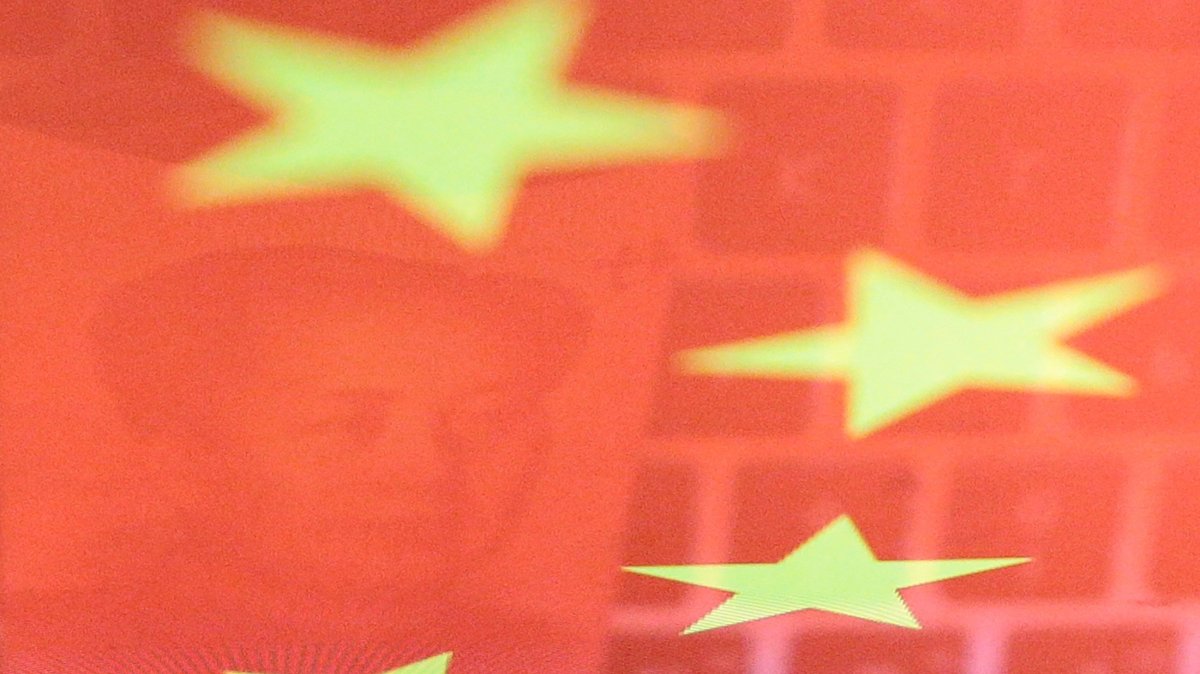 China yuan banknote featuring late Chinese leader Mao Zedong and a computer keyboard are seen reflected on an image of the Chinese flag in this illustration picture taken Nov. 1, 2019. (Reuters Photo)