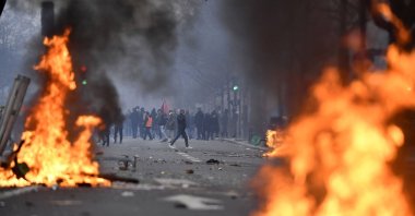 PKK terror group supporters face riot police as clashes erupt, at The Place de la Republique, in Paris, France, Dec. 24, 2022. (AFP Photo)