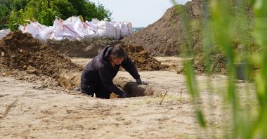 An archaeologists excavates a Viking Age pit house in Aarhus, Denmark, June 22, 2026. (AP Photo)