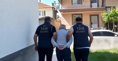 Police officers escort a FETÖ suspect in this AI enhanced photo, Ankara, Türkiye, June 24, 2026. (DHA Photo)
