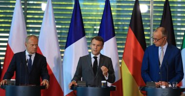 Poland's Prime Minister Donald Tusk, France's President Emmanuel Macron and German Chancellor Friedrich Merz address the press at the end of their meeting of state leaders of the European Group of Five (E5) and the NATO Secretary-General, in Berlin, June 24, 2026. (AFP Photo)